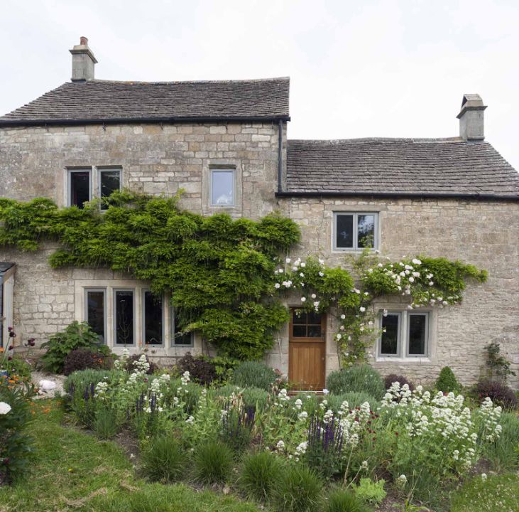 green framed windows installed in cottage