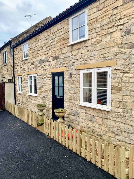 white framed sash windows installed in a brick extension house