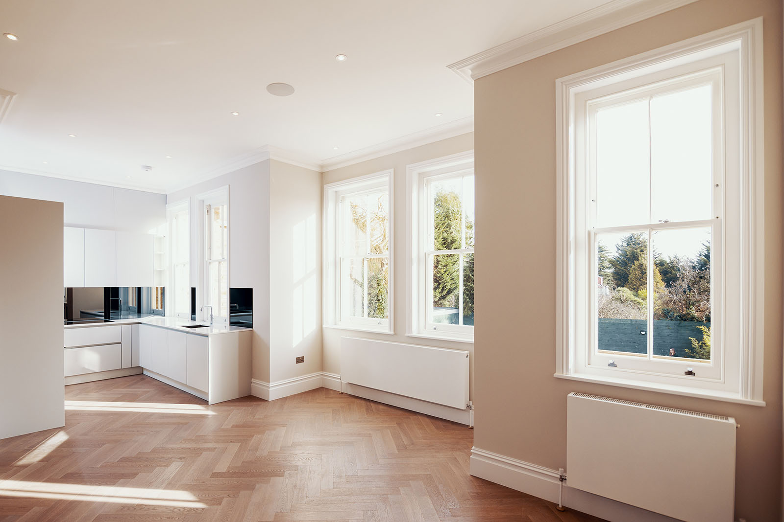 multiple white framed sliding sash windows installed in the open area of house