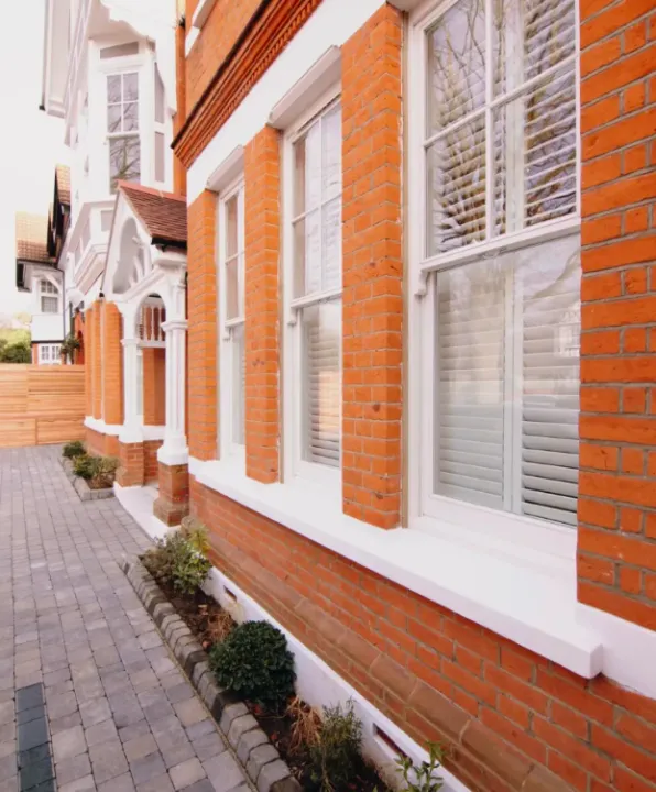 red brick house with white sash windows